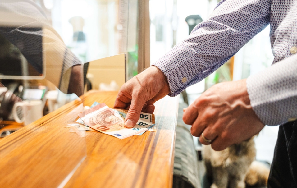 photo of hands passing money across counter